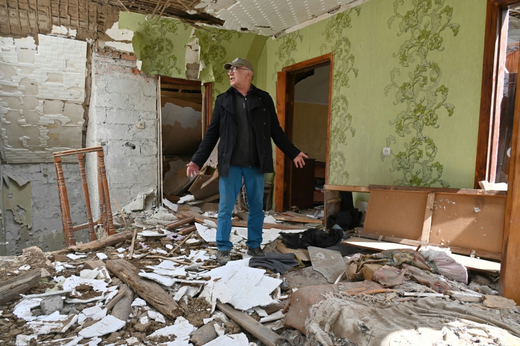 رجل بين أنقاض منزله في قرية مالا روغان إلى شرق خاركيف في أوكرانيا في 15 أيار/مايو 2022 (ا ف ب)