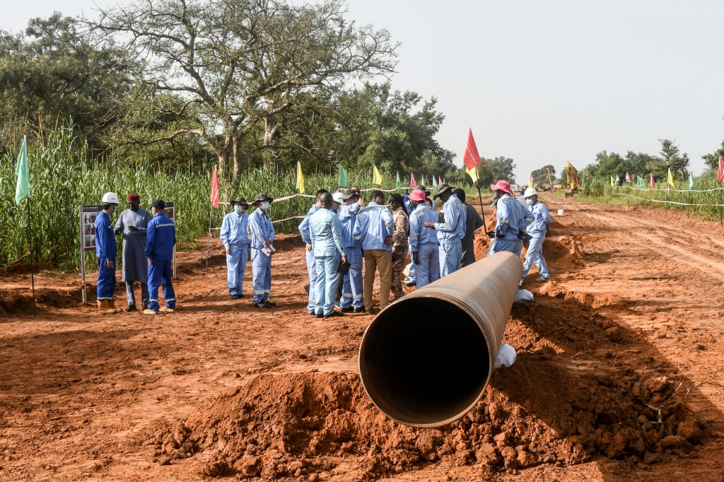 عمال من الصين والنيجر في موقع بناء مشروع خط أنابيب نفط في منطقة غايا في النيجر في 10 تشرين الأول/أكتوبر 2022 (ا ف ب)