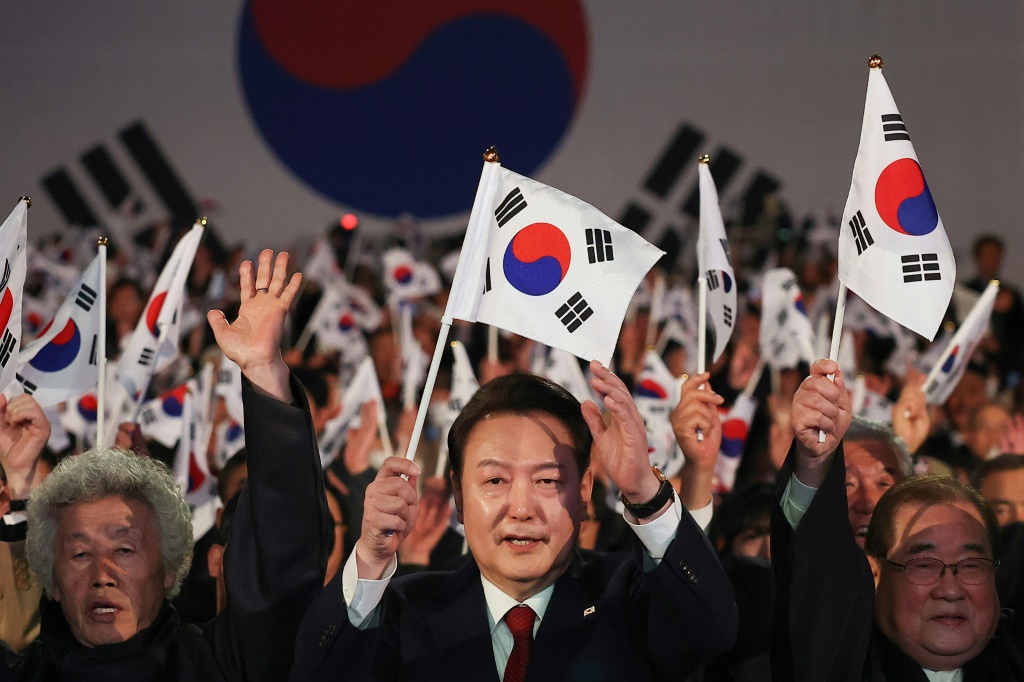 دعا الرئيس الكوري الجنوبي يون سوك يول (في الوسط) المجتمع الدولي إلى دعم "جهود التوحيد" مع كوريا الشمالية المسلحة نوويا (ا ف ب)