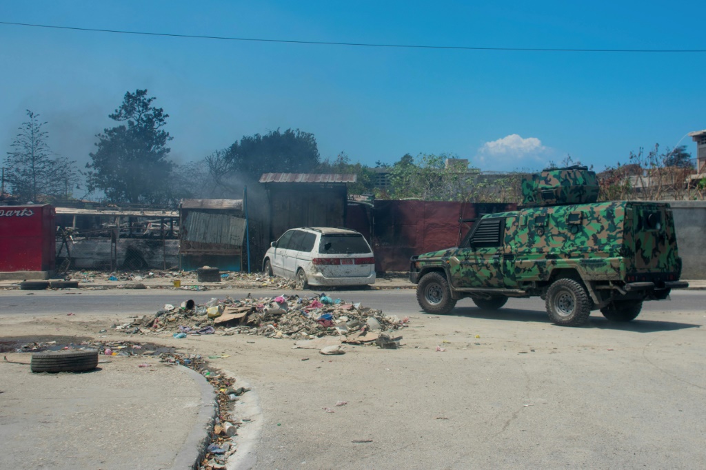 سيارة شرطة تقوم بدورية في منطقة أضرمت فيها النيران من قبل عصابات مسلحة في بورت أو برنس، هايتي (ا ف ب)